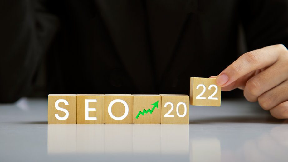 SEO, Search Engine Optimization 2022, Hand holding wooden block SEO